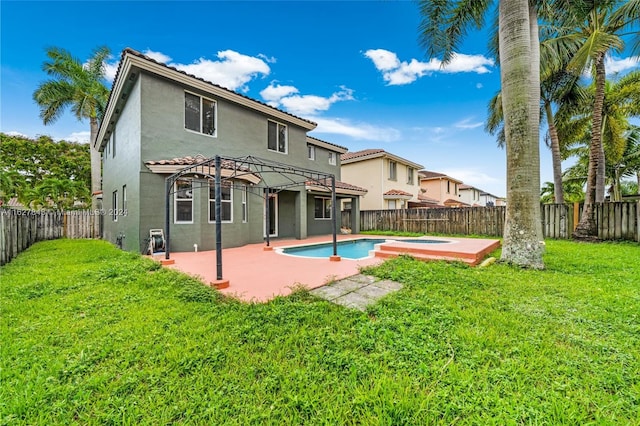 back of house with a fenced in pool, a patio, and a yard