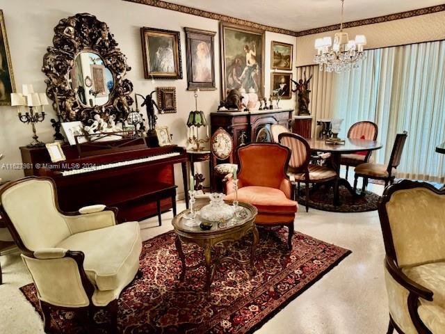 sitting room with a chandelier and speckled floor