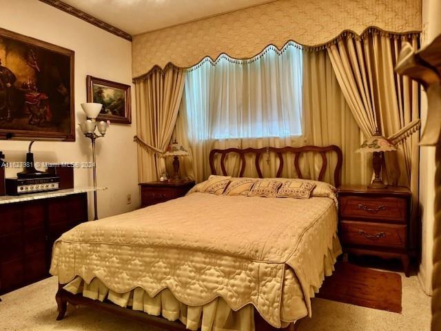 carpeted bedroom featuring ornamental molding