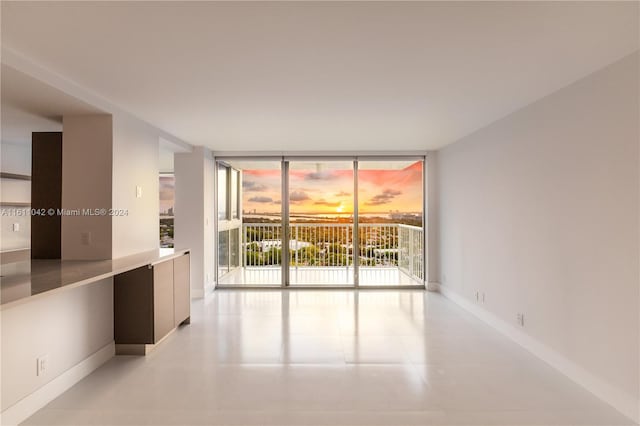 unfurnished room with expansive windows