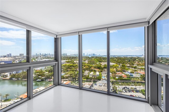 unfurnished sunroom featuring a healthy amount of sunlight and a water view