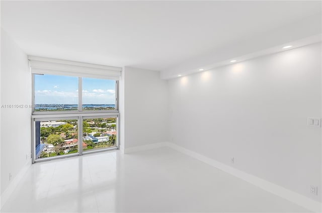 unfurnished room featuring floor to ceiling windows