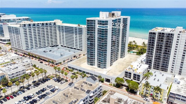 aerial view with a water view and a beach view