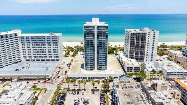 bird's eye view featuring a water view and a beach view