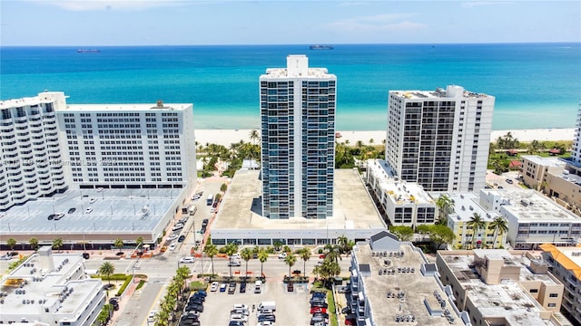 bird's eye view with a water view and a beach view