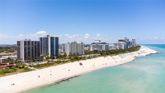 drone / aerial view featuring a water view and a beach view