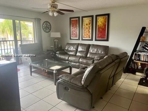 living room featuring ceiling fan and light tile patterned floors