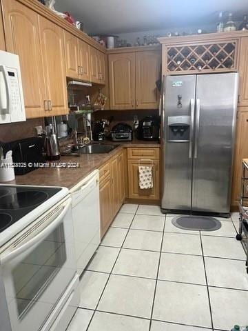 kitchen featuring white appliances and light tile patterned floors