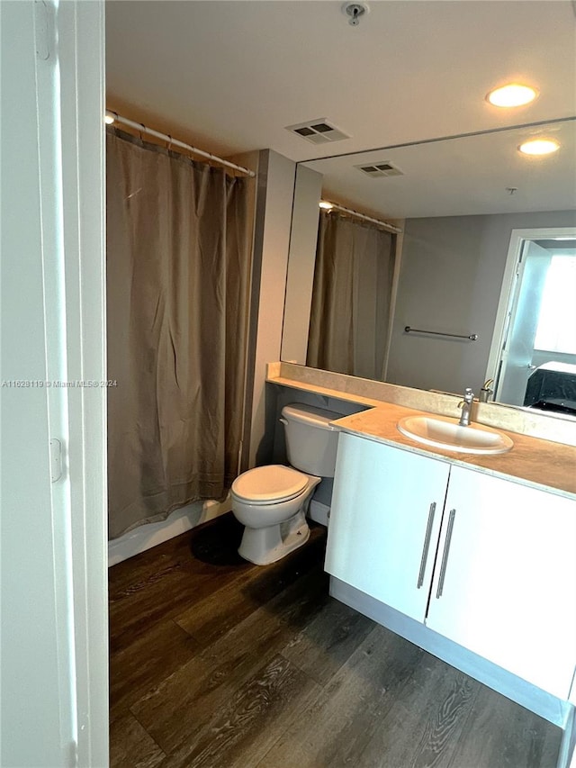 bathroom featuring hardwood / wood-style floors, toilet, and vanity