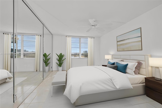 tiled bedroom featuring ceiling fan