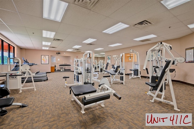 workout area featuring carpet floors and a drop ceiling