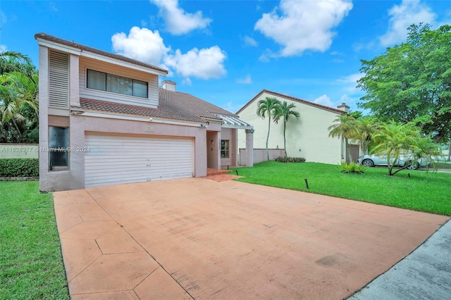 view of front of property with driveway, a garage, a tile roof, a front lawn, and stucco siding