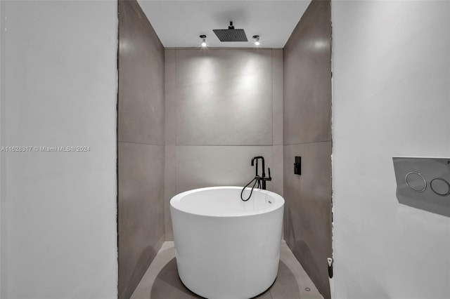 bathroom featuring a shower and a freestanding bath