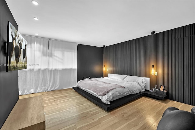 bedroom with hardwood / wood-style floors and recessed lighting