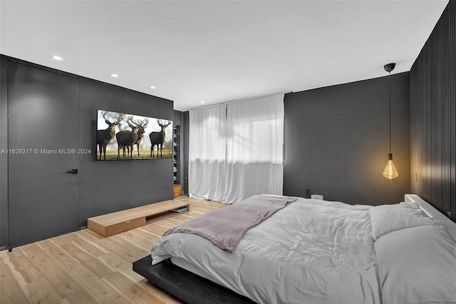 bedroom featuring recessed lighting and wood finished floors