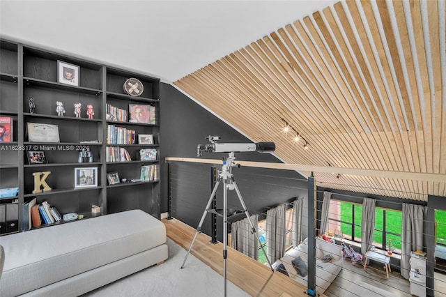 bedroom with vaulted ceiling and wood finished floors