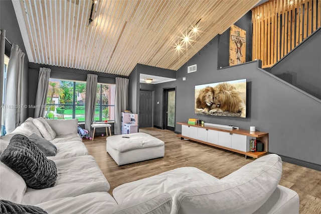 living area featuring visible vents, wood finished floors, high vaulted ceiling, wooden ceiling, and baseboards