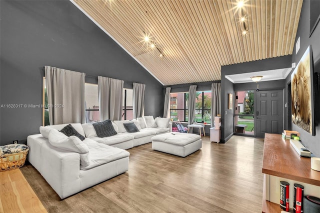 living area with high vaulted ceiling, wooden ceiling, and wood finished floors