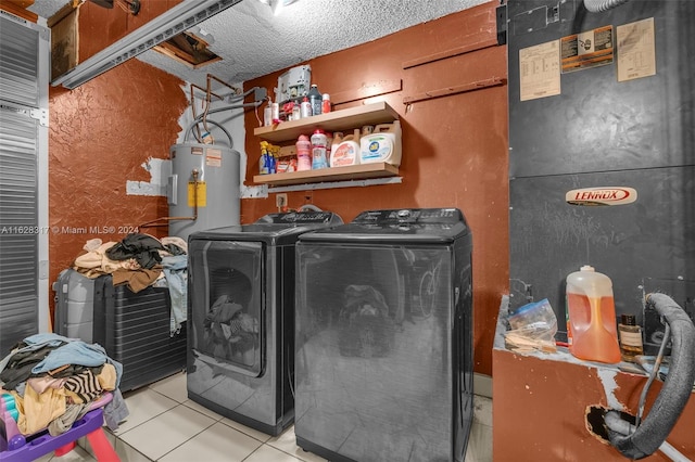 clothes washing area with electric water heater, washer and dryer, and light tile patterned floors