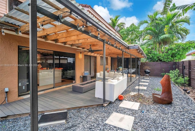 wooden terrace with an outdoor hangout area, a patio area, and a pergola