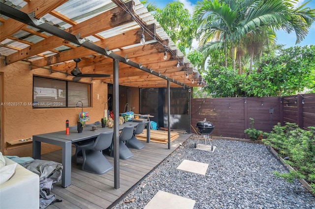 wooden terrace featuring grilling area and ceiling fan