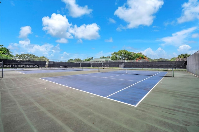 view of tennis court with fence