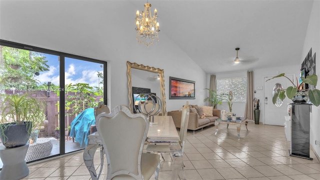 tiled dining space featuring lofted ceiling and a chandelier