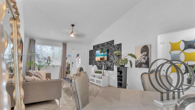 tiled dining area with vaulted ceiling