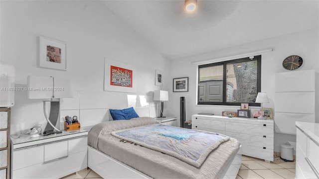 tiled bedroom with lofted ceiling