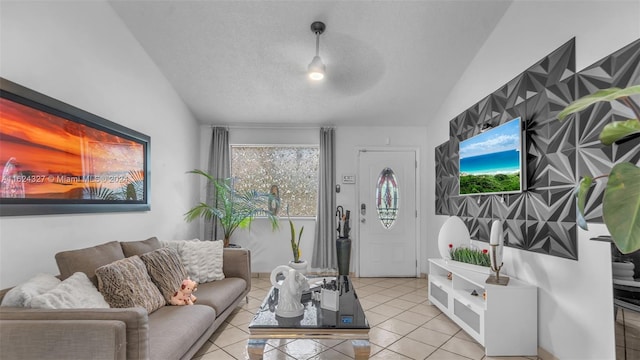 living room with vaulted ceiling, light tile patterned floors, and a textured ceiling