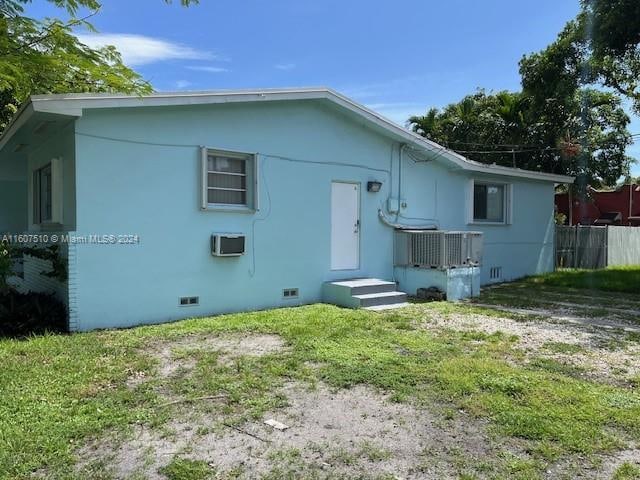 rear view of property featuring a yard