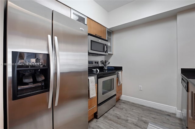 kitchen with light hardwood / wood-style floors and appliances with stainless steel finishes