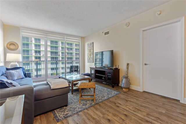 living room featuring hardwood / wood-style floors and a textured ceiling