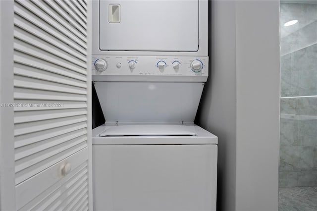 clothes washing area featuring stacked washer / dryer