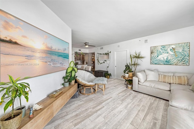 living room featuring hardwood / wood-style flooring and ceiling fan