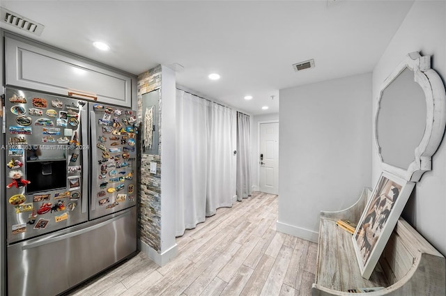 kitchen with stainless steel refrigerator with ice dispenser, light hardwood / wood-style flooring, and gray cabinetry