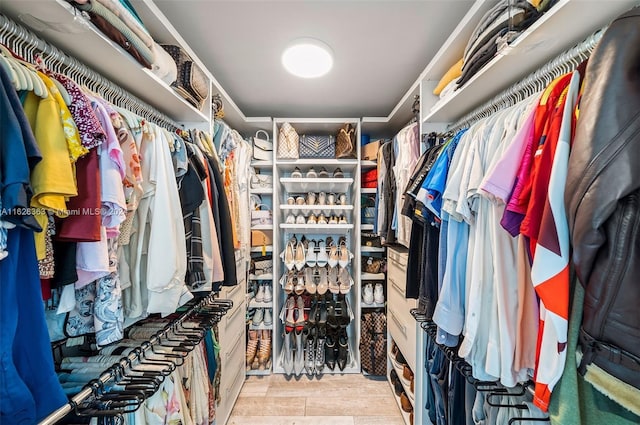 walk in closet with light wood-type flooring