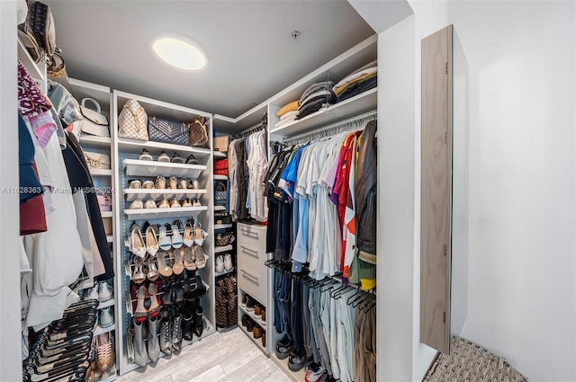 spacious closet with light hardwood / wood-style floors