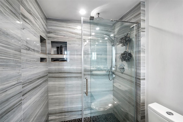 bathroom with walk in shower and toilet