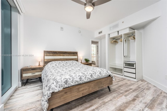 bedroom featuring a closet, ceiling fan, and light wood-type flooring