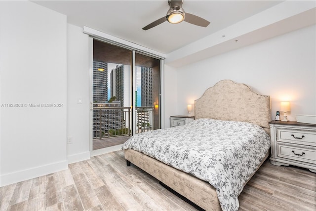 bedroom with access to exterior, light hardwood / wood-style flooring, floor to ceiling windows, and ceiling fan