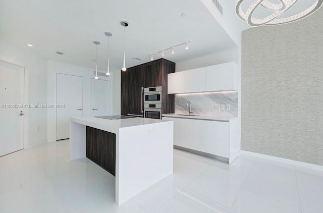 kitchen featuring hanging light fixtures, dark brown cabinetry, white cabinets, a kitchen island, and black electric cooktop