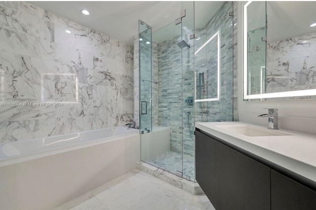 bathroom featuring shower with separate bathtub, tile walls, and vanity