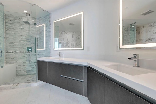 bathroom with vanity and a shower with door