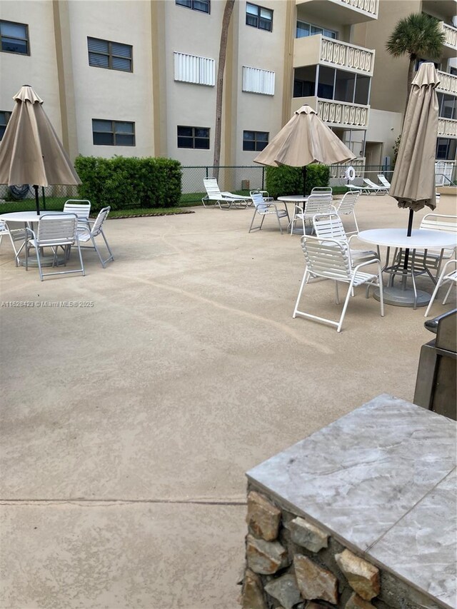 view of patio featuring a balcony