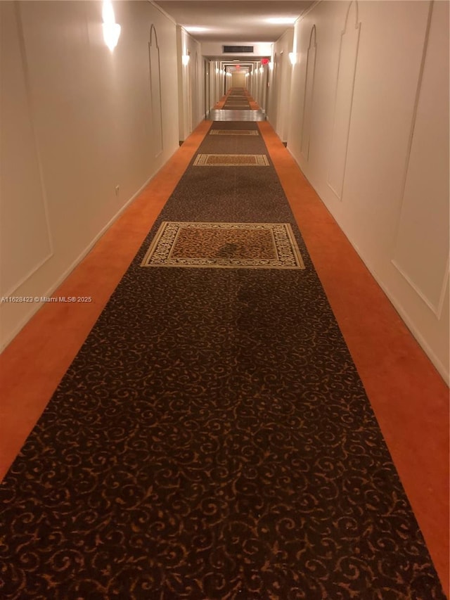 800 NE 195th St Unit 314, Miami, FL 33179 - corridor featuring a decorative wall and light colored carpet