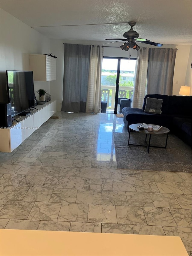 living room featuring a textured ceiling, ceiling fan, and light tile patterned floors