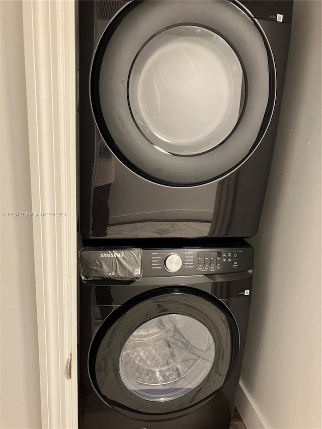 washroom with stacked washer and clothes dryer