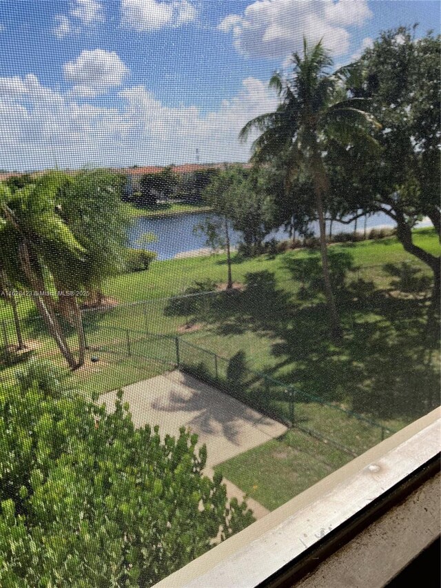 view of property's community featuring a water view and a yard