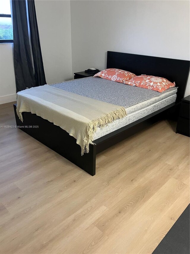 bedroom with light hardwood / wood-style floors